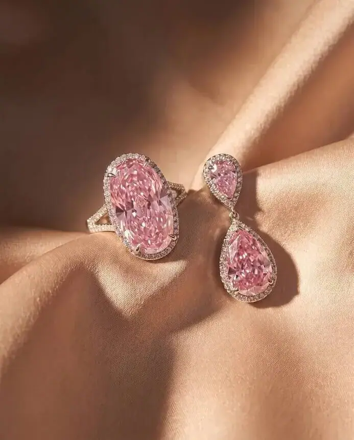High jewellery campaign image: pink diamond ring and earrings on silk, product-accurate