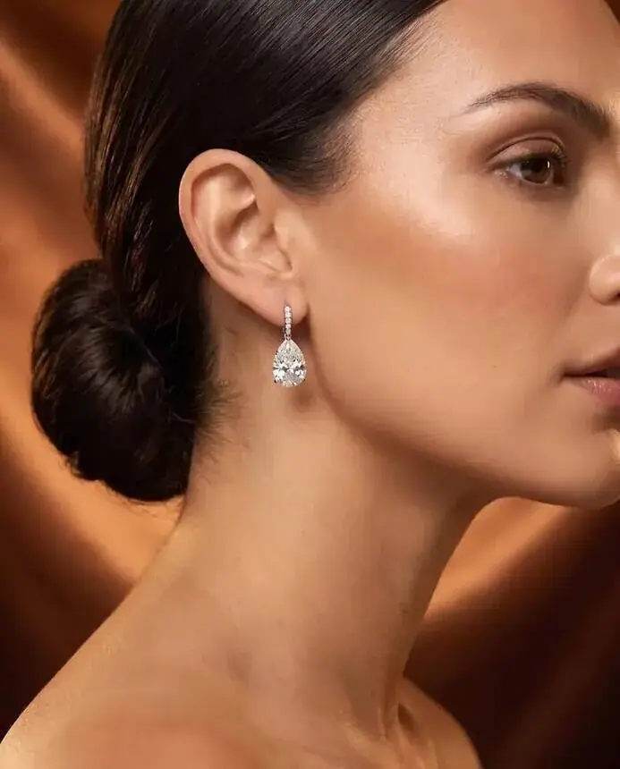 Jewellery campaign imagery for a luxury brand: diamond drop earring on a model