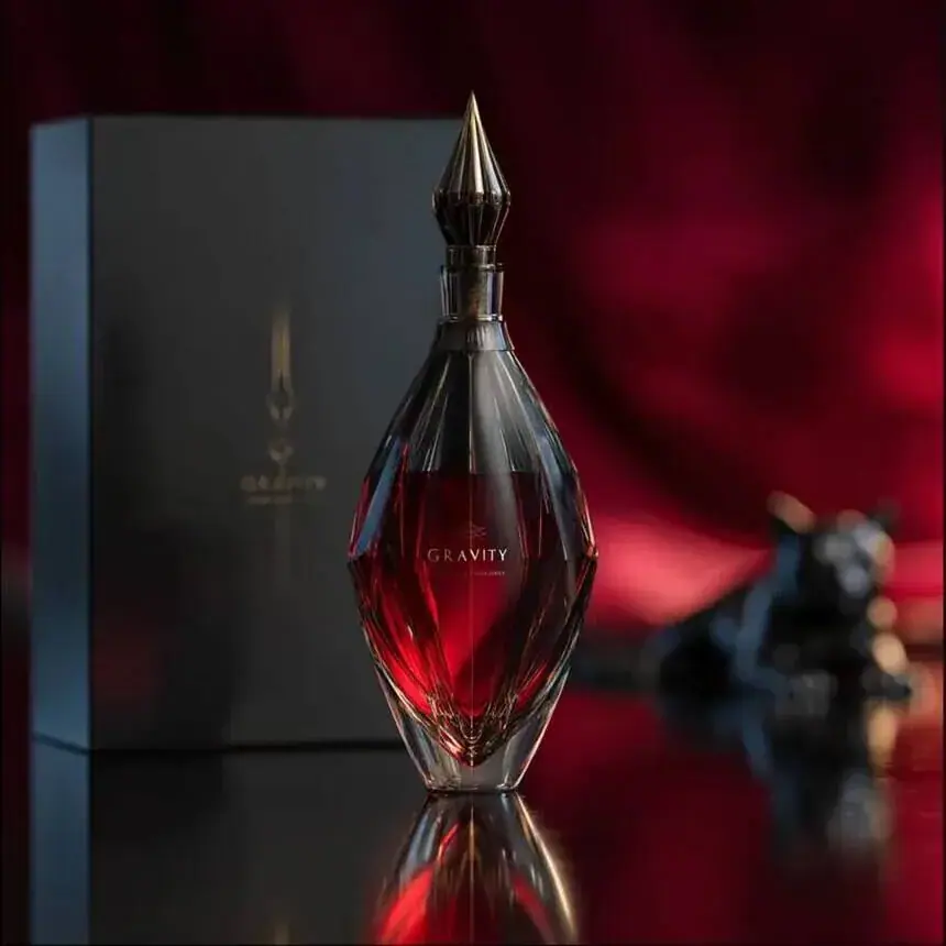 Fragrance campaign image for a perfume brand: ruby bottle in a lacquered box, red silk